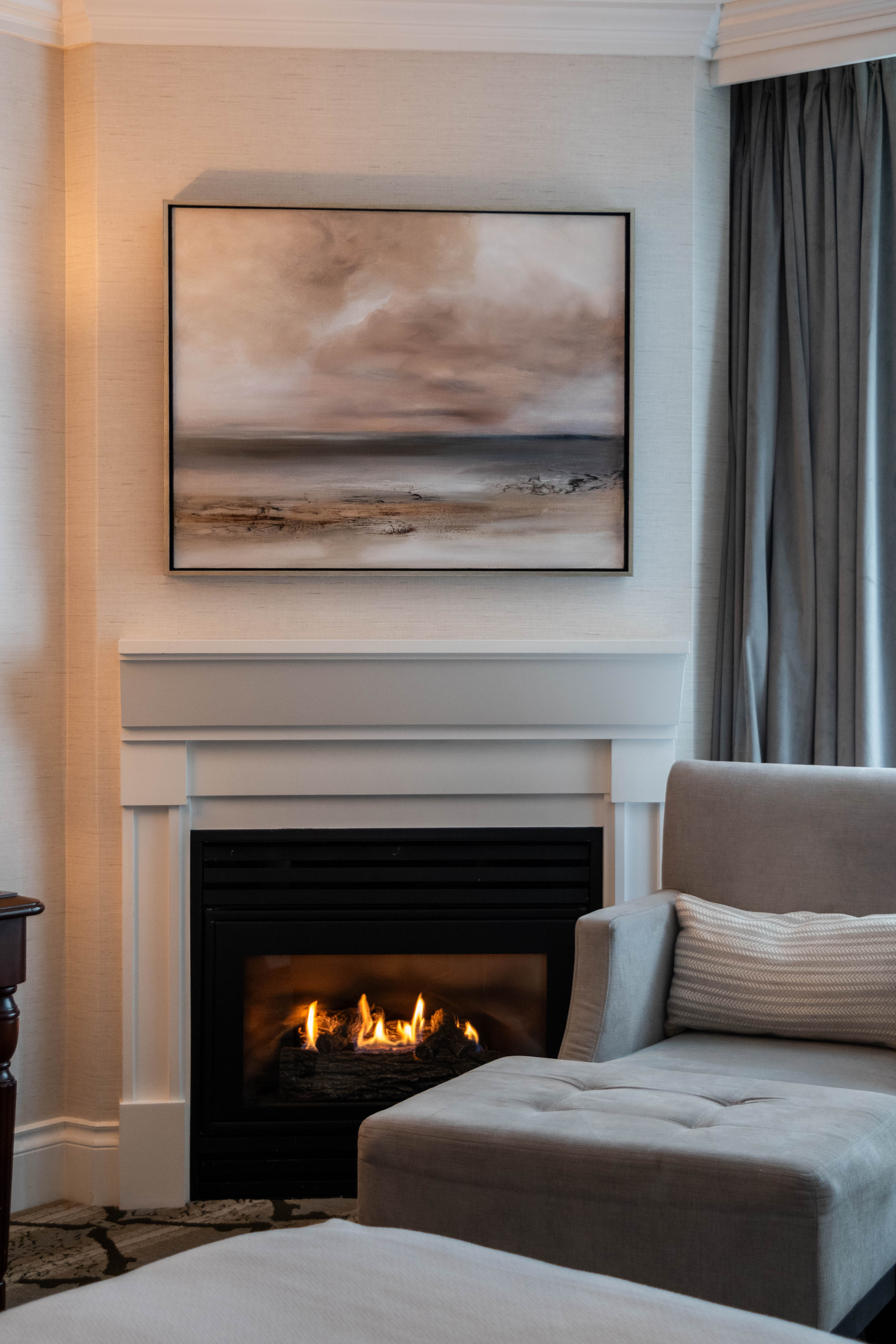 A shot of the seating area in a Diamond City Room at Magnolia Hotel  Spa featuring original artwork by Victoria artist Donna Anderson