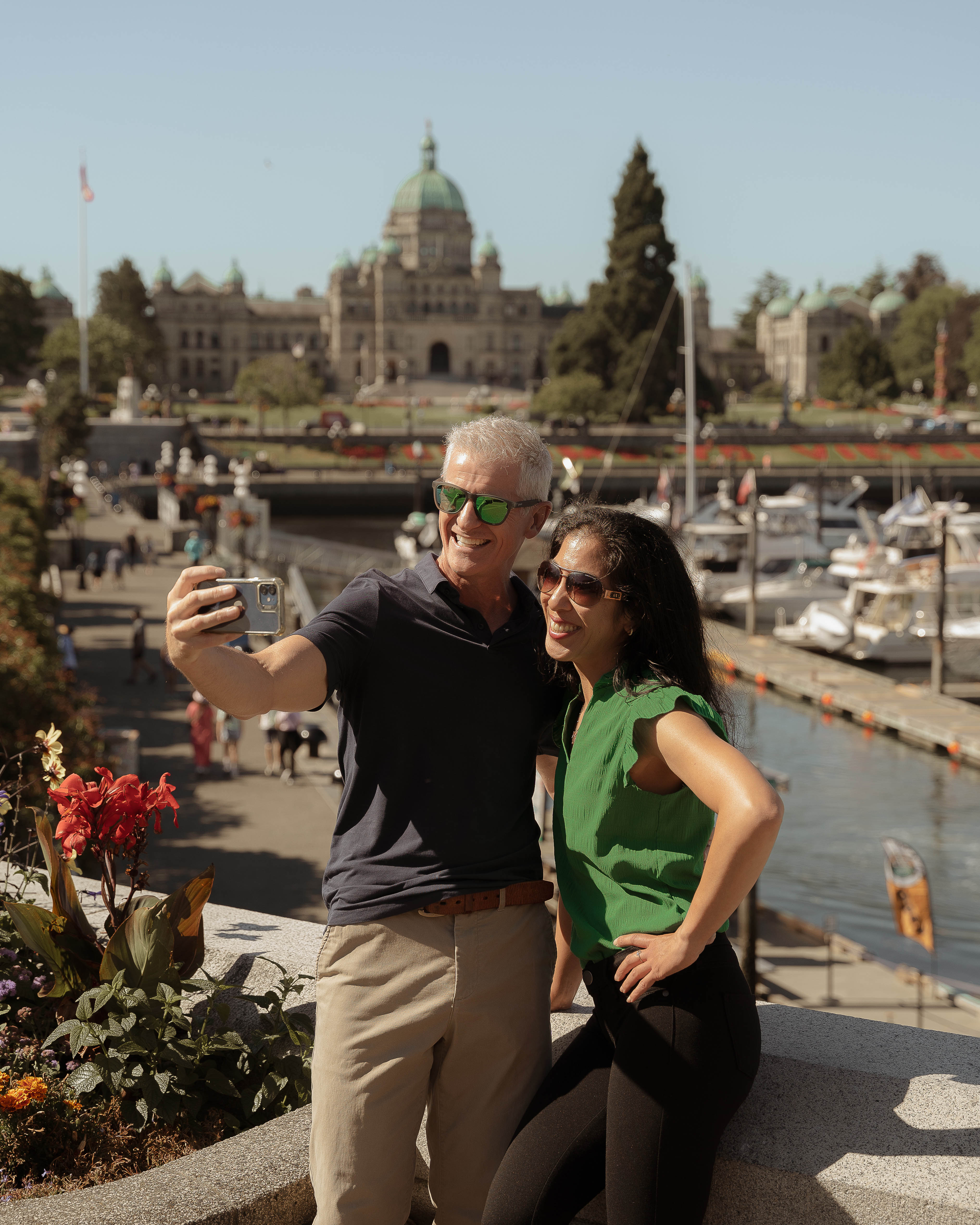 A couple takes a selfie in Victoria's Inner Harbour