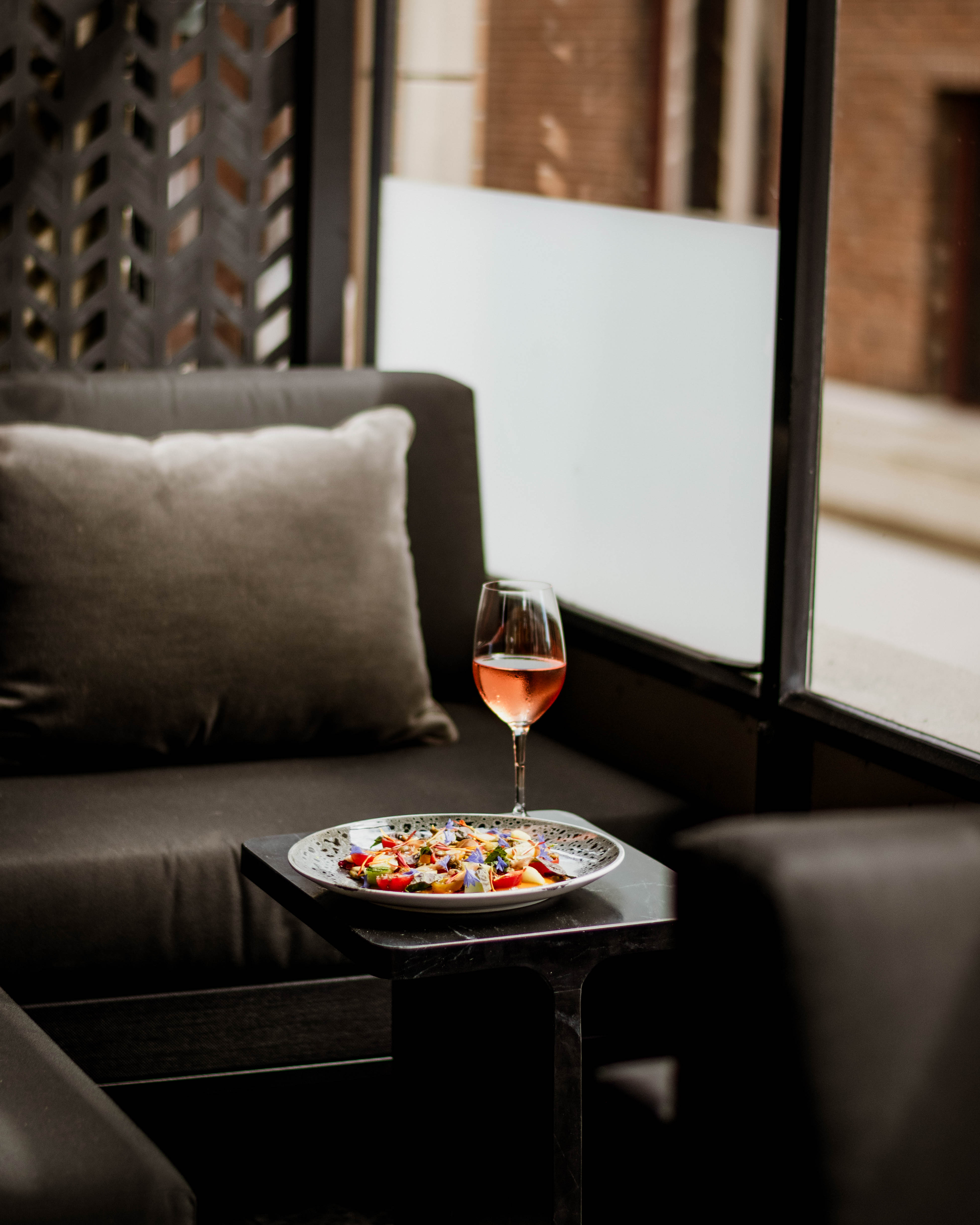 A glass of wine and a summer dish on the patio at The Courtney Room